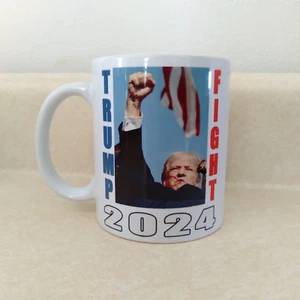 TRUMP 2024 MUG ASSASSINATION FIGHT FIST RAISED DEFIANCE - Picture 1 of 3
