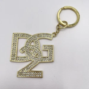 Schlüsselanhänger Diane Gilman DG2 goldfarben Kristall Logo Taschenanhänger Glitzer Designer Geschenk - Bild 1 von 8