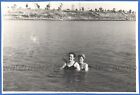 Beautiful women in swimsuits are swimming in the river Vintage photo
