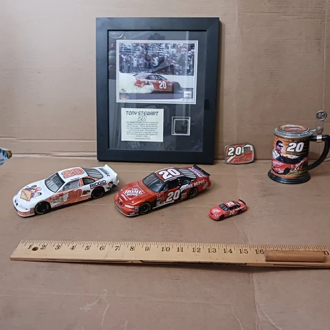 Tony Stewart NASCAR items - plaque, signed trading card, diecast cars, more Cover