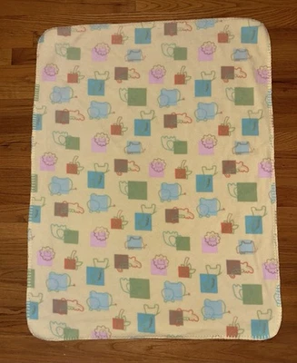 Manta de bebé Circo Target polar amarilla Lovey cuadrados formas hipopótamo león jirafa Foto 1 de 4