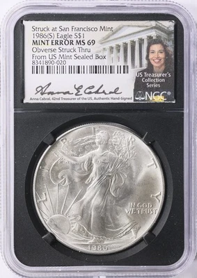 MINT ERROR 1986 SILVER EAGLE STRUCK THRU NGC MS69 CABRAL - Image 1 of 2