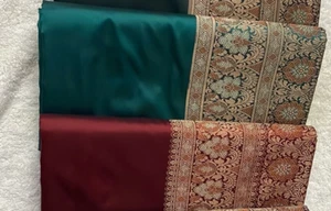 The fabric in the image is a rich maroon charm of the Buta Leya Soft Silk Saree - Picture 1 of 4