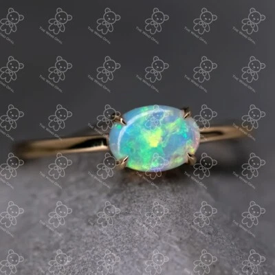 Anillo de compromiso de oro amarillo de 18 quilates con ópalo macizo australiano en forma de ovalado Foto 1 de 4