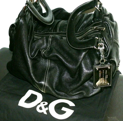  $2275.00 BOLSO CLUTCH DOLCE & GABBANA ITALIA CUERO GENUINO NEGRO MISS RIZADO  Foto 1 de 4