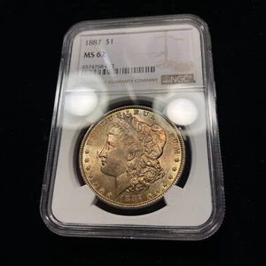 1887 Morgan Silver Dollar $1 NGC MS62 Old Uncirculated BU Orange Toning++ - Picture 1 of 3
