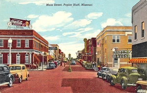Poplar Bluff MO Street View Coca-Cola Billboard Store Fronts Old Cars Postcard - Picture 1 of 2