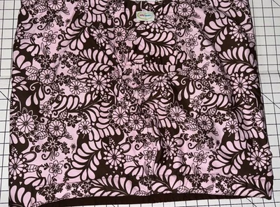 Eslinga reversible para bebé Munchkin Jelly Bean rosa marrón diseño floral Foto 1 de 4