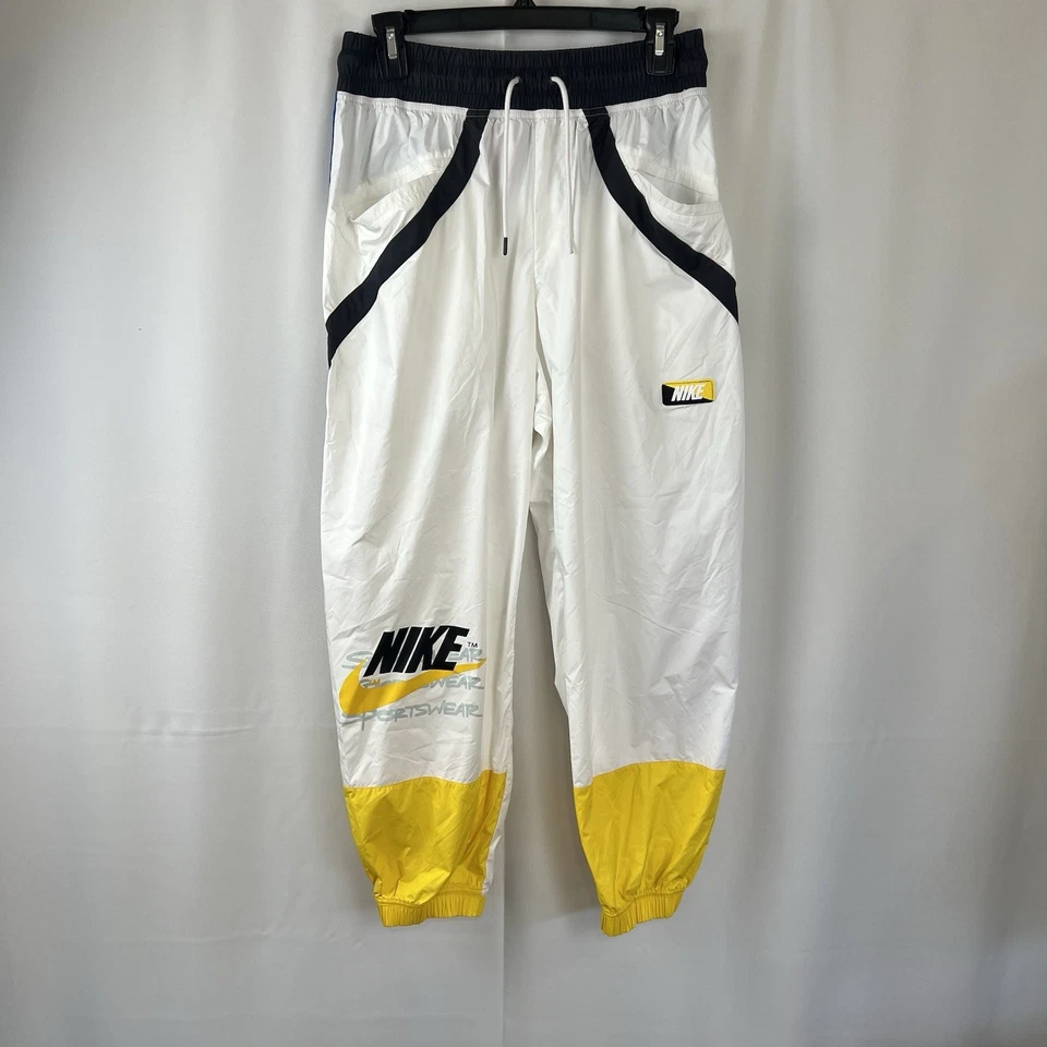 Pantalones deportivos ligeros vintage para niños talla mediana Nike años 90 amarillos Wind Foto 1 de 4