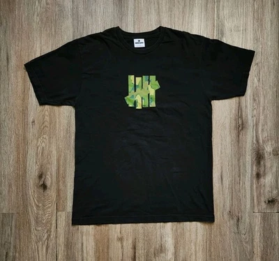 Camiseta Undefeated 5 Strike Verde Camuflaje Logo Para Hombre Talla Grande Negra Manga Corta Foto 1 de 4