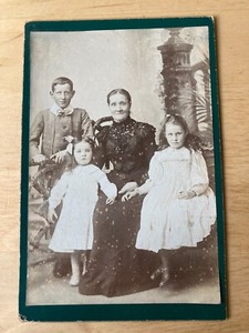 Cabinet Card:  Woman with two girls and boy in front of a tower.