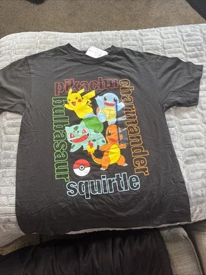 Camiseta Pokémon Niños Talla L Pikachu Squirtle Charmander Bulbasaur Negra Nueva con Etiquetas Foto 1 de 4