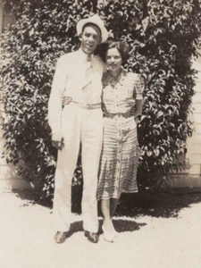 1934 Couple Smiling Man Light Suit Hat Woman Patterned Dress Portrait - Picture 1 of 3