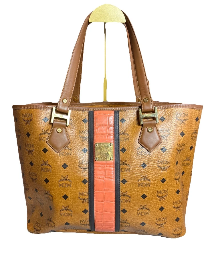 This is an MCM Visetos monogram tote bag with leather trim and a central stripe. - Image 1 of 4