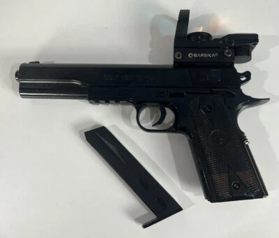 Pistola Colt 1911 Target Airsoft preta com carregador Barska ponto vermelho AC10632 - Imagem 1 de 4