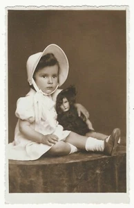 PORTRAIT OF A LITTLE GIRL WEARING A BONNET : HOLDING A DOLL OR PUPPET (1939) - Picture 1 of 3
