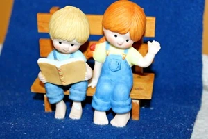 Boy And Girl Sitting On A Wooden Bench - Picture 1 of 8