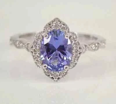 Anillo de compromiso con halo de tanzanita natural de corte ovalado de 4,00 quilates de oro blanco sólido de 14 quilates Foto 1 de 4