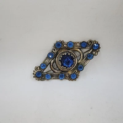 Broche de moda tono plateado piedra azul usado Foto 1 de 4