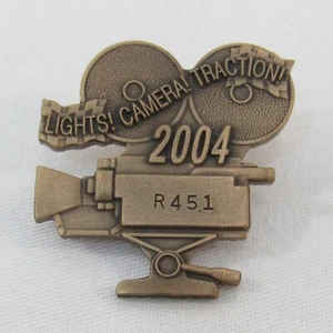 2004 Indy 500 Pit Badge #R451 Bronze Pit Badge Camera Lights! Camera! Traction! - Picture 1 of 5
