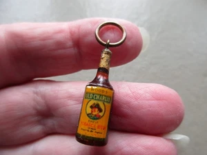 ANTIQUE VINTAGE LUCITE WOODS RUM BOTTLE GOLD TONE ADVERTISING FOB CHARM PENDANT - Picture 1 of 8