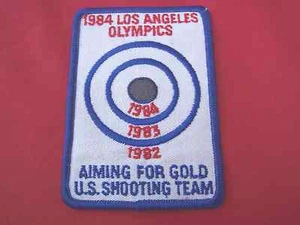 Toppa oro vintage 1984 Olimpiadi di Los Angeles squadra di tiro olimpico USA che mira - Foto 1 di 1