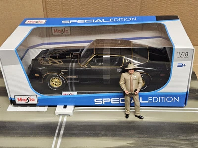 1:18 GMP SHERIFF G1800150 and Maisto Pontiac Firebird Trans Am Black with Gold - Image 1 of 3