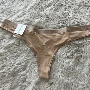 *** Calvin Klein Women's SZ L Cotton Essentials Thong QD3748 - 265 Tan $15 - Picture 1 of 9
