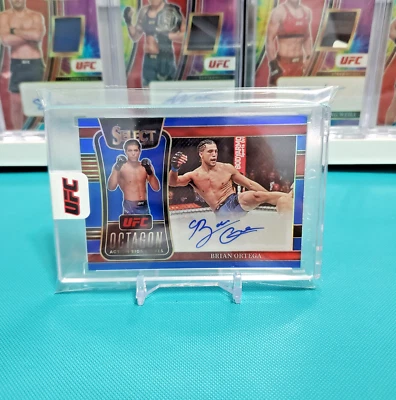 2022 Panini Select UFC  Brian Ortega Blue Prizm Auto /49 Action Signatures - Image 1 of 4