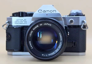 Canon AE-1 Program fotocamera reflex pellicola 35mm + obiettivo 50mm f/1.4 FD - testata e funzionante - Foto 1 di 24