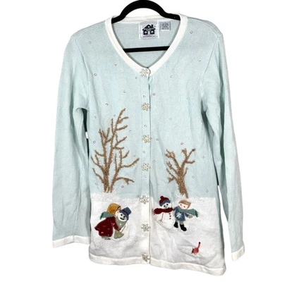 Libro de cuentos tejidos bailando en la nieve muñeco de nieve azul crema cárdigan suéter pequeño Foto 1 de 4