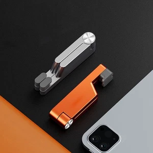 Support t��l��phone aluminium noir orange pliable design portable et pliable - Photo 1 sur 15