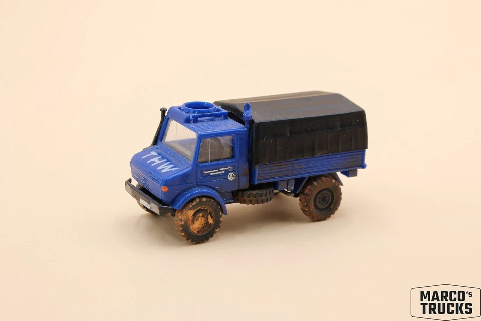 Roco Mercedes-Benz Unimog flatbed/tarpaulin “THW” weathered 1:87 /RO619 - Image 1 of 1