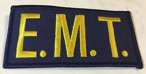 "Parche bordado EMT letras de oro amarillo sobre fondo azul marino 4""X2""" - Imagen 1 de 1