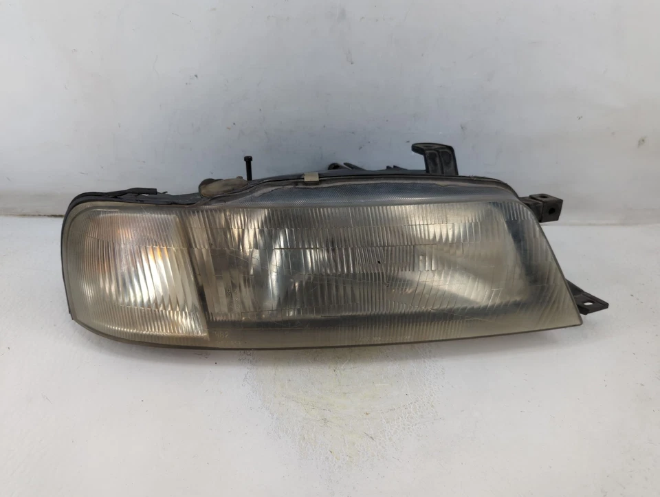 Faro luz izquierda conductor Suzuki Esteem 1995-1998 OEM YNN9O Foto 1 de 4