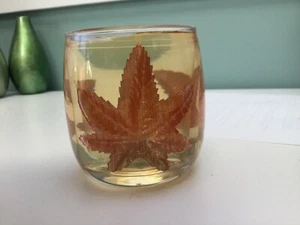 Gel candle in glass holder, with artificial leaves pressed into item  - Picture 1 of 1