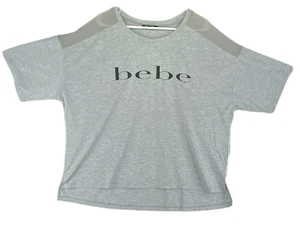 Bebe Sport Mujer Talla 2X Camisa Gris con Logotipo Negro y Tira Transparente para el Hombro - Imagen 1 de 11