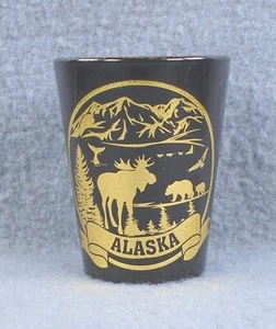 Souvenir ALASKA BLACK SHOT GLASS gold painted logo Moose Bear Husky shotglass - Picture 1 of 5
