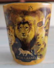 MGM GRAND THE LION KING BLACK AND YELLOW CERAMIC SHOT GLASS 2.25 INCHES 1.5 OZS