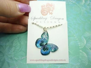 Little Butterfly Necklace, Blue and Black on a Sparkle Silver Plated Chain - Foto 1 di 2
