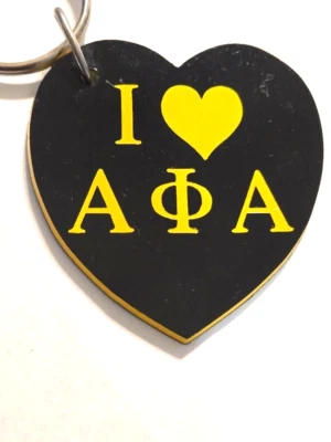 Llavero vintage (años 90) Alpha Phi Alpha plástico negro y dorado [3"], usado Foto 1 de 3