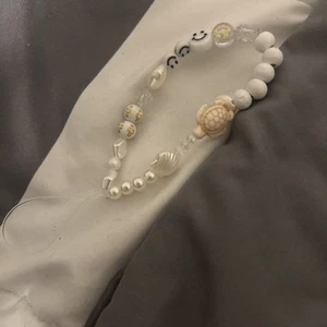 bead phone charm. white, turtle, smiley beads. - Picture 1 of 4