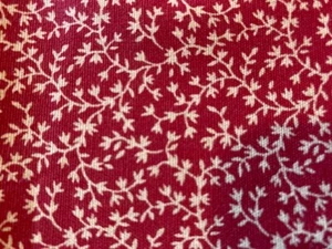 500115 Red Fabric with Tan Leaf Pattern - 1 2/3 Yds. x 42" Wide - Picture 1 of 3