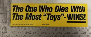 Vintage 1980s Bumper Sticker Decal The One Who Dies With The Most Toys Wins - Picture 1 of 4