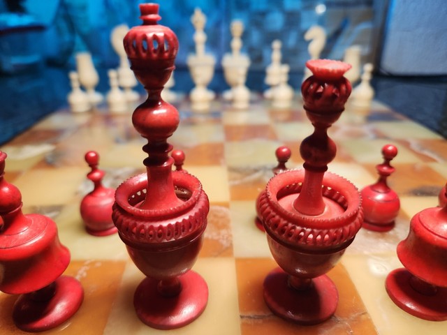 Chess pieces: 32 red and white ivory pieces without board., Complete number  of pieces of a chess game. Sixteen cut ivory pieces that have been made red  with a dyestuff: these are