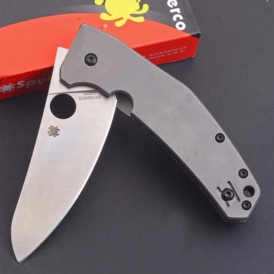 Cuchillo plegable de bolsillo con mango de titanio de calidad de lavado de piedra D2 hoja de acero aleta Foto 1 de 4