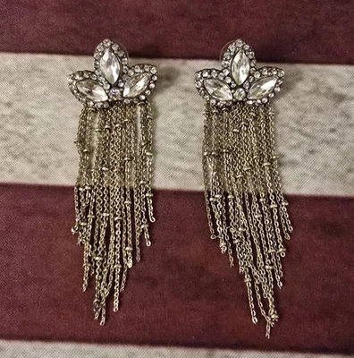 А pair of gold-tone dangle earrings,with clear crystal embellishments and chain. - Image 1 of 4