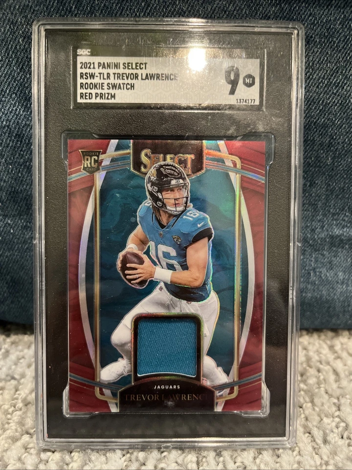 2021 Panini Select Rookie Swatches Trevor Lawrence #RSW-TLR Red Prizm (MEM, RC) - Image 1 of 2