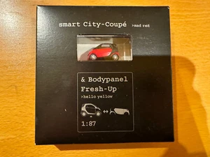 Smartware 1/87 Model - Smart Car City Coupe - Mad Red with Hello Yellow Panels - Picture 1 of 3