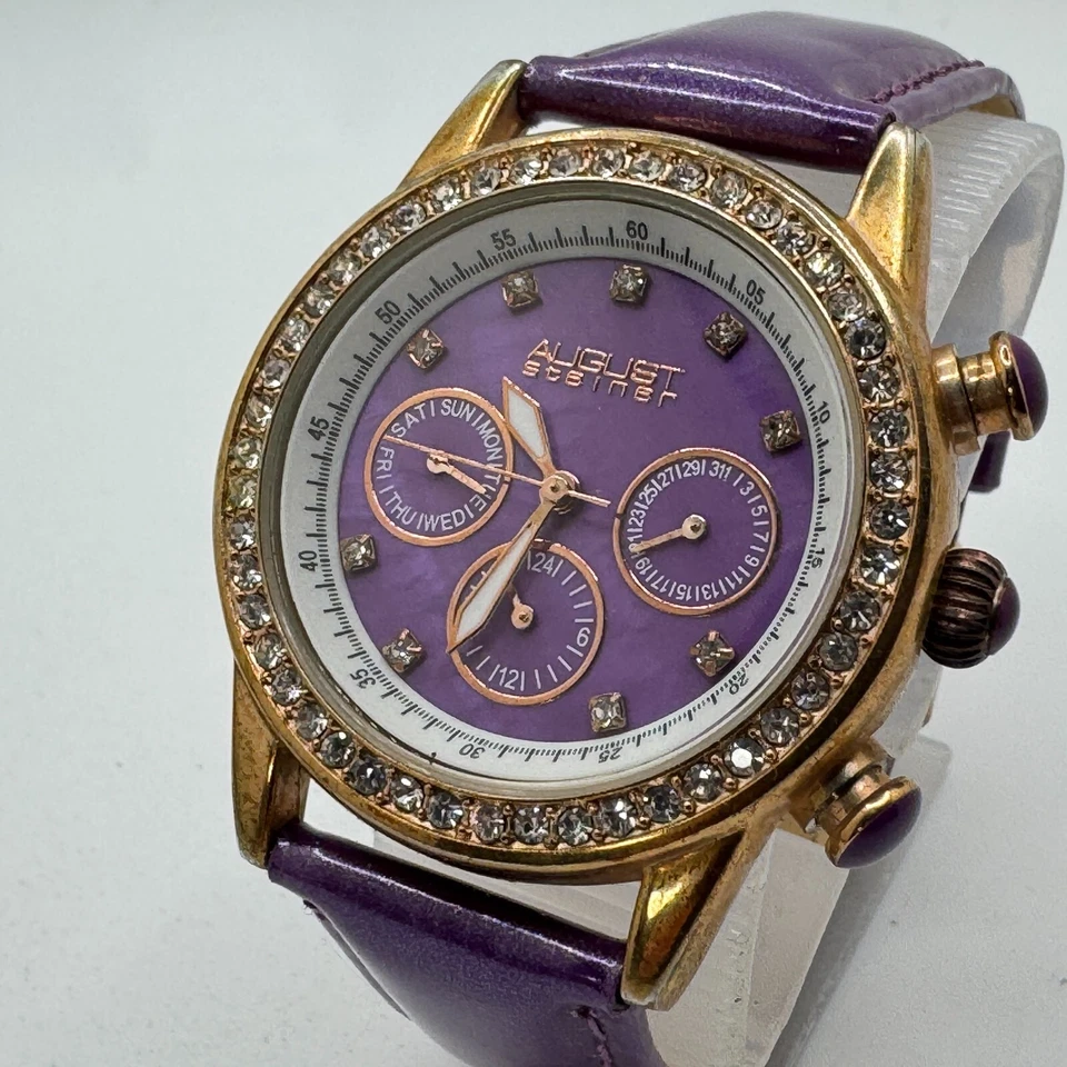 August Steiner Quartz Watch Women Gold Tone Purple Rhinestone Day Date New Batte - Image 1 of 4